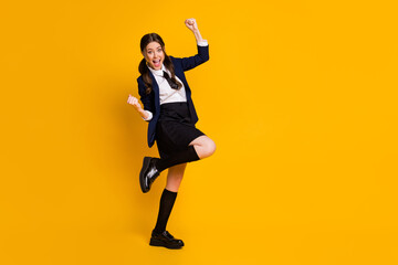 Fototapeta na wymiar Full length body size view of her she nice attractive pretty lovely overjoyed lucky cheerful cheery schoolgirl celebrating excellent mark isolated on bright vivid shine vibrant yellow color background
