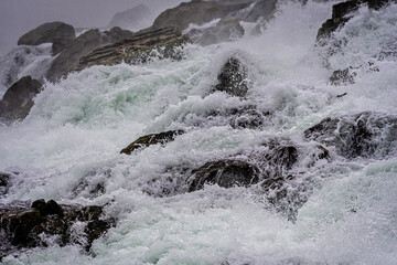 Splashes of the Niagara falls in a sunny day
