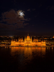 Fototapeta na wymiar Aerial drone shot of Hungarian Parliament with lights on during Budapest evening