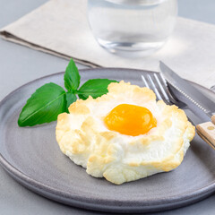 Trendy cloud or fluffy egg dish on  gray plate, square format