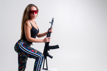 Beautiful woman with rifle plastic. Army girl Holding Gun