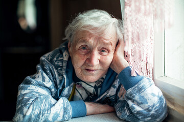 Portrait of an elderly woman in her home.