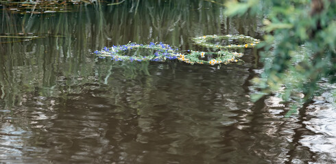 Wreaths of flowers floating on the water