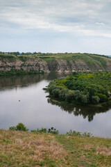 Fototapeta premium View of the river Dniester, canyon Podilsky Tovtry, Green hills. The nature of Ukraine. Nature Reserves and Forests