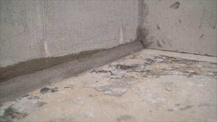 Concrete floor before work. The concrete floor in the apartment is ready for processing. Ready floor level in the apartment. Freshly prepared floor with mortar.