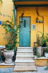 Bright yellow house with plants