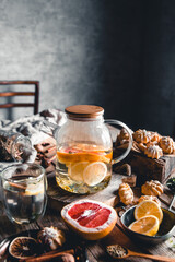 Fototapeta na wymiar Hot tea with slices of fresh grapefruit on wooden tablet. Healthy drink, Eco, vegan