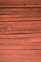 Close up of a wooden cottage with deep Falu red or falun red paint. This is a dye that is used in a deep red paint, well known for its use on wooden cottages and barns in Sweden and Finland