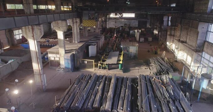 Metal round billets in a warehouse, metal in an indoor warehouse, span over metal in a warehouse