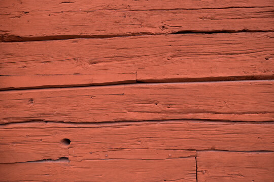 Close up of a wooden cottage with deep Falu red or falun red paint. This is a dye that is used in a deep red paint, well known for its use on wooden cottages and barns in Sweden and Finland
