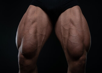Muscled male legs on isolated background