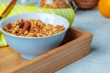 Bowl with granola on wooden table close up