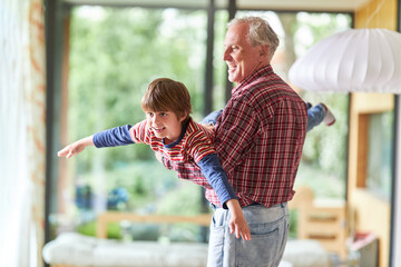 Grandpa lets grandson fly at home