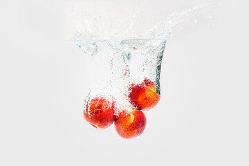 Fresh Nectarines with water splash against white background