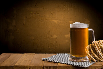 Beer style- bottle, beer in the glass and covers on wooden table. Free space for text. Top view