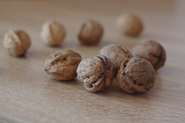 Different walnuts on a wooden table