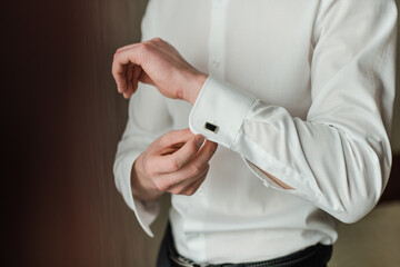 groom in a white shirt, man buttoning cufflink, White shirt