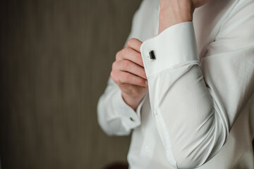 groom in a white shirt, man buttoning cufflink, White shirt