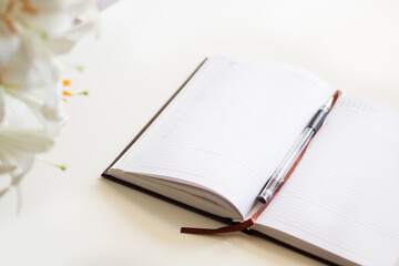  Open journal, a bouquet of lilies on a white background