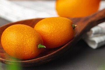 Heap of kumquat fruit on kitchen table