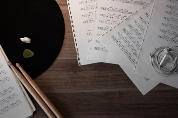 Composition with drumsticks and music sheets. The view from the top.