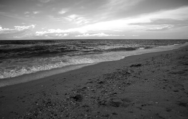 Seascape. Blue sky, sea and yellow sand. Postcard with seascape. Copy space. Black and white photography. Monochrome photography