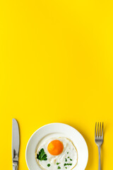 Fried eggs on plate - yellow desk top view space for text