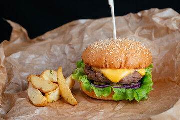 hamburger with fries on a wooden background