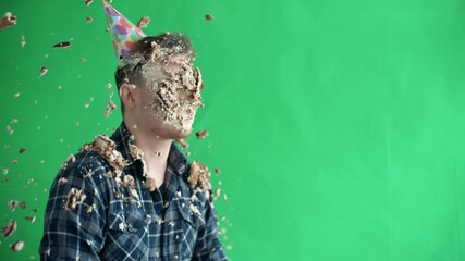 Throw birthday cake at mans face, he smiles and laughs in slow motion
