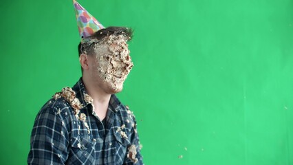 Throw birthday cake at mans face, he smiles and laughs in slow motion