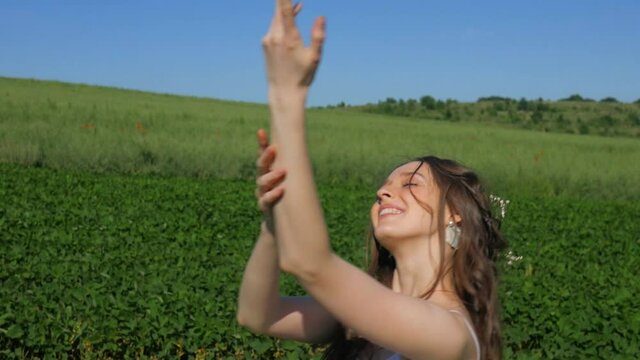 Beautiful happy girl. Young woman laughs at the camera. Summer, linen field, blue sky.