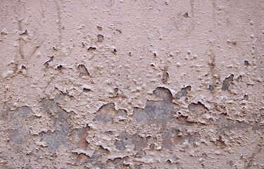 old gray wall of concrete with peeling paint - rough dirty texture for a background surface