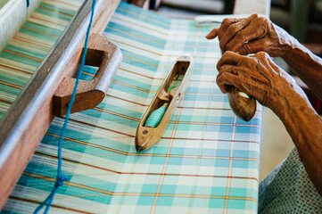 Fototapeta premium Handmade Thai fabric, cotton weaved loom machine with weaving Loom Shuttles
