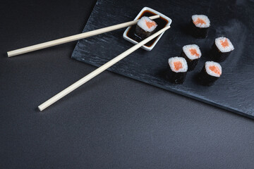 Sushi on a black background. Perfect for creating a sushi restaurant menu. Japanese cuisine, Eastern culture.