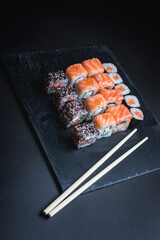 Sushi on a black background. Perfect for creating a sushi restaurant menu. Japanese cuisine, Eastern culture.