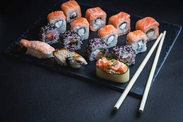 Sushi on a black background. Perfect for creating a sushi restaurant menu. Japanese cuisine, Eastern culture.