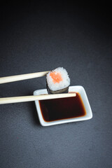 Set of traditional japanese food on a dark background. Sushi rolls. Asian food frame. Dinner party. 