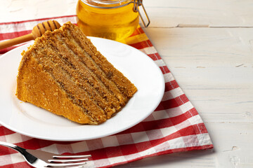 Slice of layered honey cake on plate
