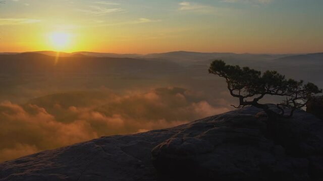 Timelapse of a foggy sunrise at the Lilienstein in the Elbe Sandstone Mountains, Saxon Switzerland, Germany.
