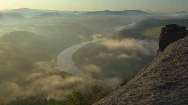 Timelapse at the Lilienstein in the Elbe Sandstone Mountains, Saxon Switzerland, Germany. Early morning fog,