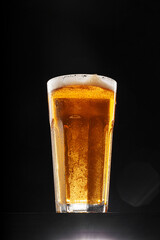 Glass of beer on black background, copy space