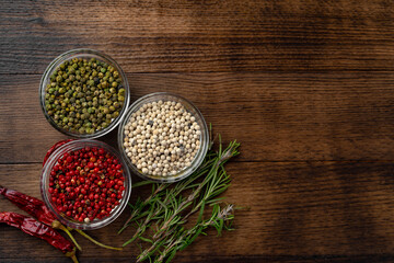 Bowls with assorted spices on dark background