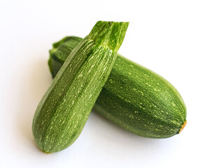 Green zucchini on a white background. The harvest of zucchini. Vegetarian food.