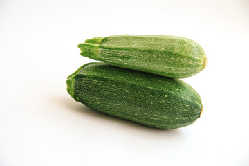 Green zucchini on a white background. The harvest of zucchini. Vegetarian food.