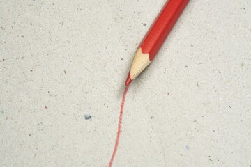 Red line drawn by a red pencil on a grungy surface