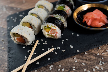 Sushi roll set on the black plate. Japanese food.