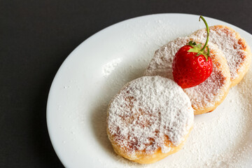 Ukrainian Cuisine Syrniki With Powdered Sugar And Strawberry Close-Up In A Plate. Horizontal