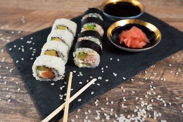 Sushi roll set on the black plate. Japanese food.