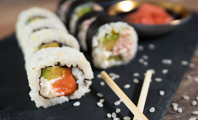 Sushi roll set on the black plate. Japanese food.