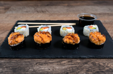 Sushi roll set on the black plate. Japanese food.